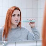 une femme qui se brosse les dents